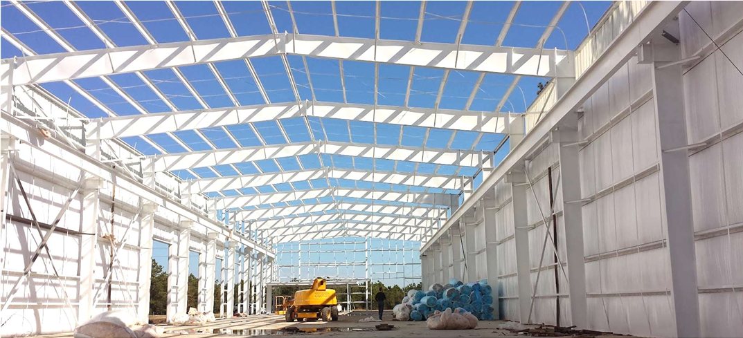 Metal building interior with white faced insulation installed