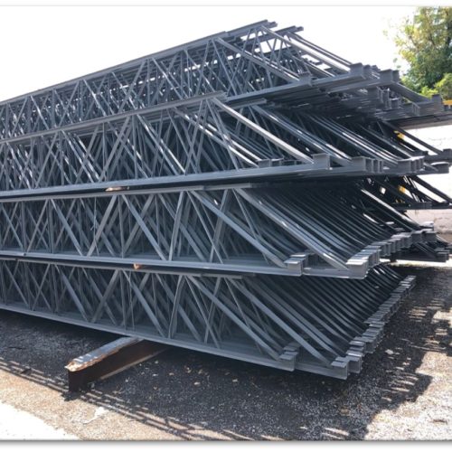 Bundles of steel joists with visible diagonal web members